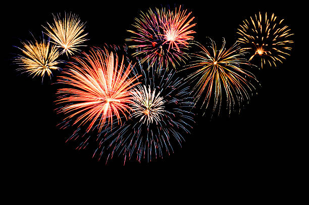 a fireworks display against the night sky - vuurwerk stockfoto's en -beelden