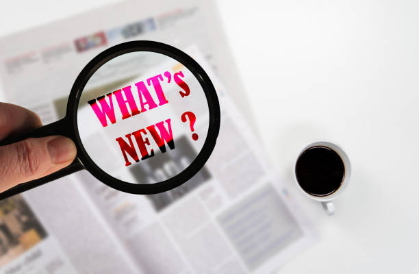 istock Text what's new on a newspaper with a magnifying glass. 1352004982