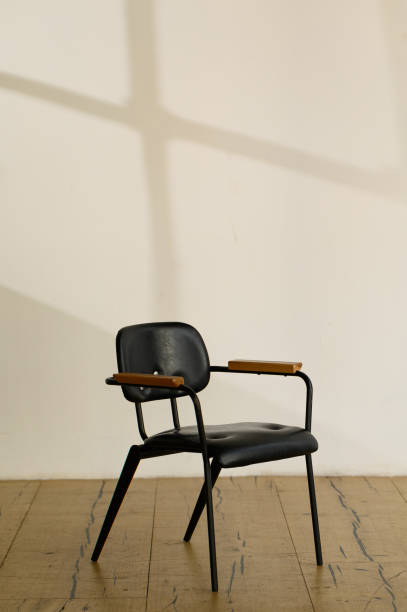 istock black office leather armchair against empty walls in office interior withcopyspace. Vertical frame 1352006146