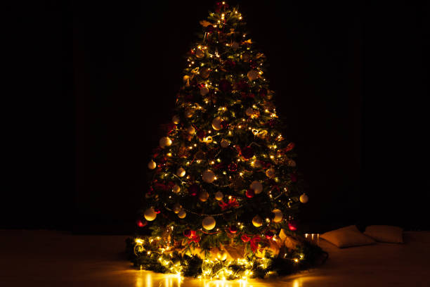 istock Christmas tree with gift lights garland decor new year 1352006211