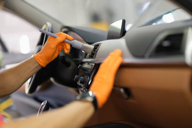 istock A man brushes dust inside a car, hands close-up 1352006553