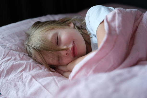istock Little girl sleeping peacefully on the bed 1352006581