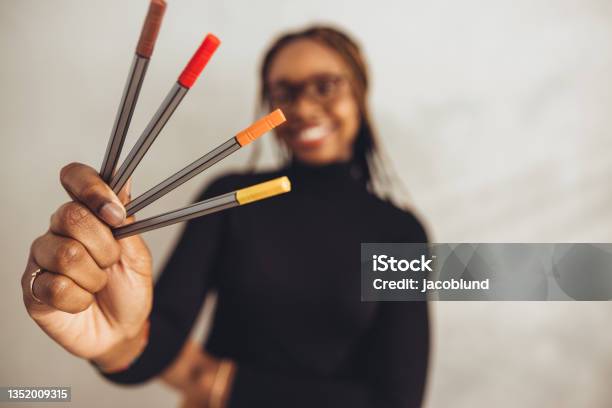 Creative Designer Holding Coloured Pens Stock Photo - Download Image Now - One Woman Only, Close-up, Pen