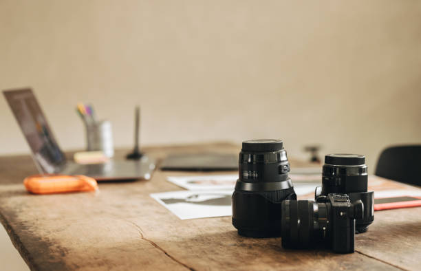Shot of a photographer's workstation at home. Still life shot of a desk with a DSLR camera and other photographic equipment.