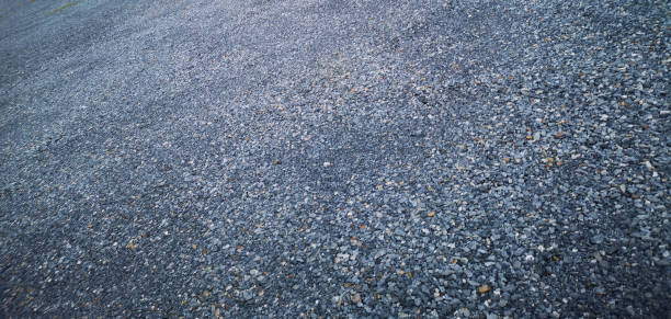 istock Abstract background with pebbles small round sea stones Beach rocks Texture material nature, Rock the specifics, grey black color 1352012614