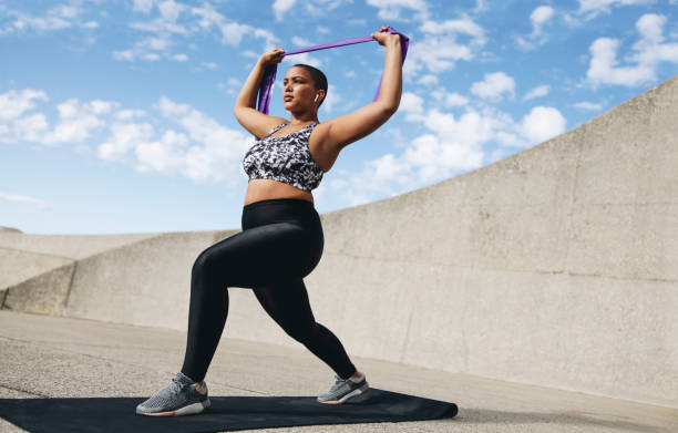 istock Athletic woman exercising with a resistance band 1352012892