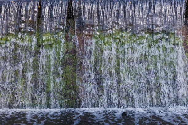 istock Fragment of an artificial waterfall formed by the concrete dam 1352013329