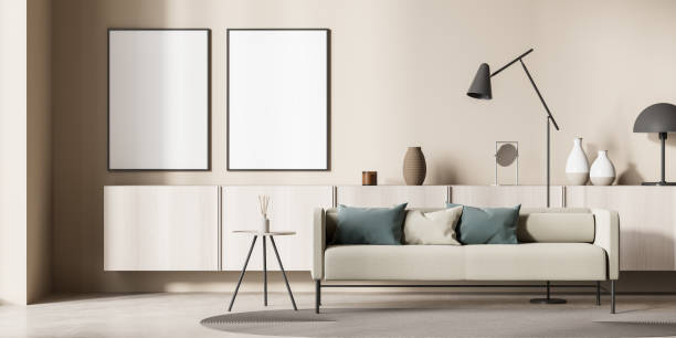 istock Beige living room with green deatils and two empty canvases 1352013509