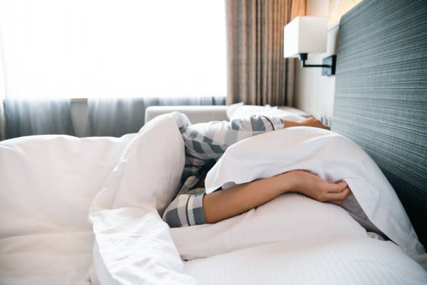 istock Lazy woman waking up from the bed. 1352014509