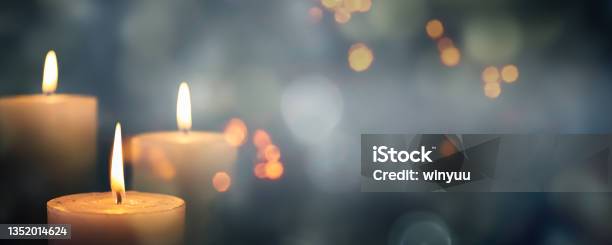 Closeup Of 3 Burning Candles On Abstract Black Background Contemplate Celebration Mood With Blurry Lights Festive Concept With Copy Space Stock Photo - Download Image Now