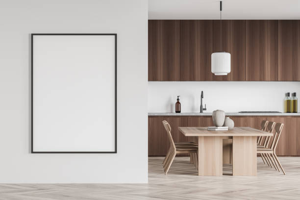 istock Mockup frame on white wall in minimalist wood kitchen with dining table 1352015151