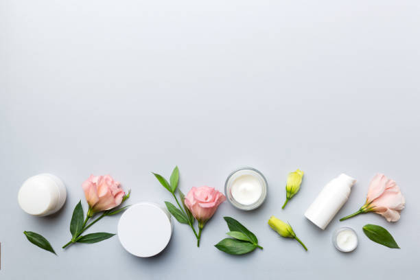 istock Composition with cosmetic products and beautiful roses on color background. Copy space, flat lay 1352015300