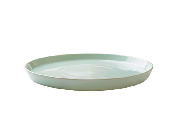 istock Blue ceramic round plate isolated over white background. perspective view 1352015354