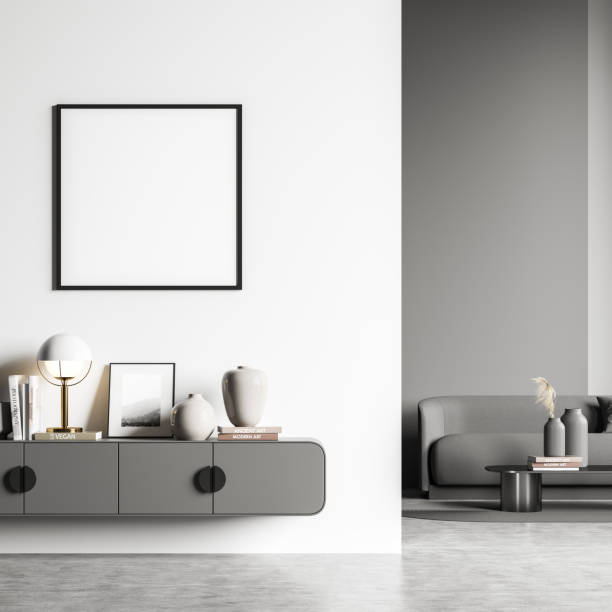 istock White and grey living room areas with empty square frame on wall 1352015438