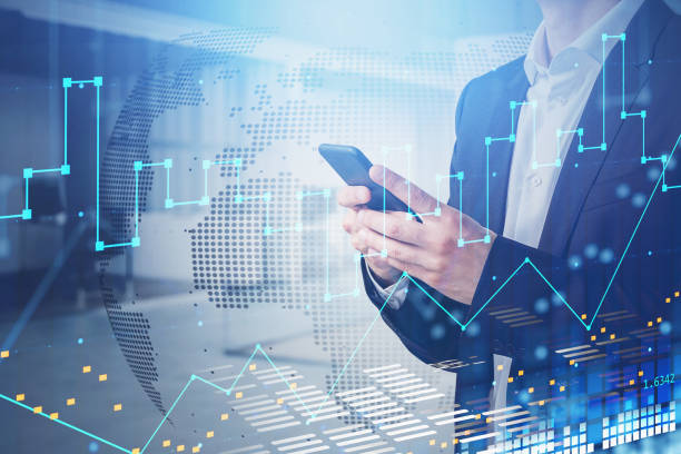 istock Businessman in suit with smartphone in hands analyzing stock market changes based on worldwide news, double exposure, hologram globe and charts. 1352015676
