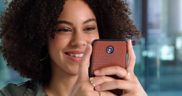 istock Shot of a young woman using her phone at work 1352016802