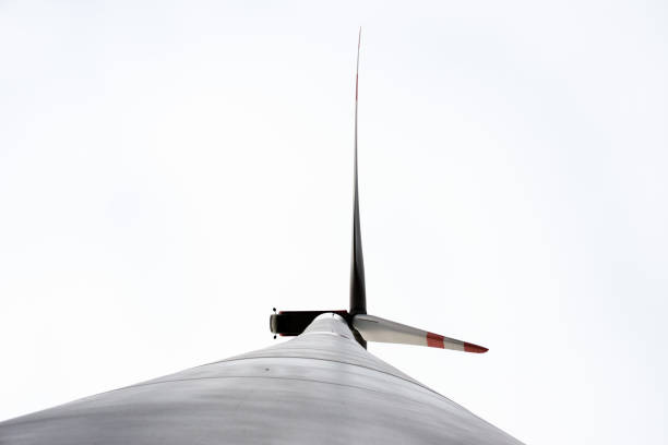istock A wind turbine with red stripes against a gray cloudy sky 1352016805