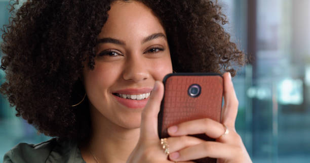 istock Shot of a young woman using her phone at work 1352016810