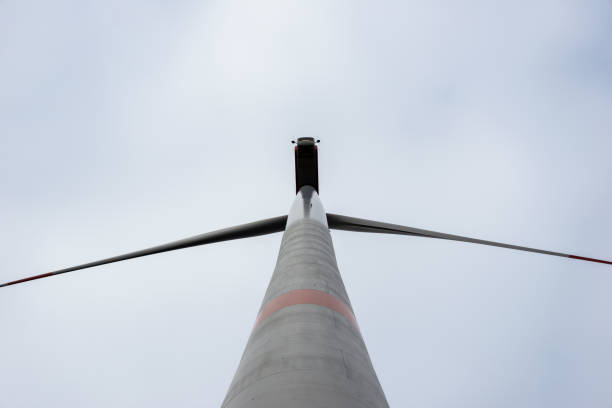 istock A wind turbine with red stripes against a gray cloudy sky 1352016990
