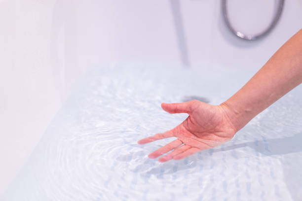 istock Woman checking a water temperature. 1352017445