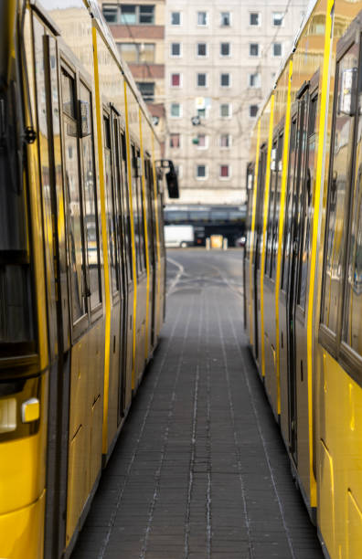 istock Tram On Railroad Tracks Amidst Buildings In City 1352021507