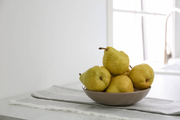 istock Fresh ripe pears on countertop in kitchen 1352021569