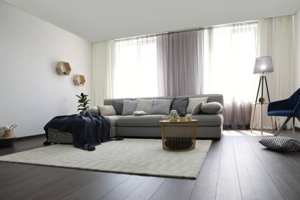 istock Elegant living room with comfortable sofa near windows. Interior design 1352021780