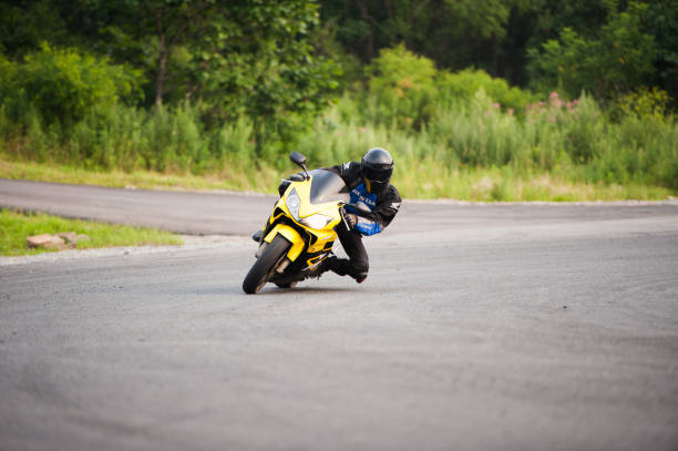 A man on a sports motorcycle is driving along the road. stock photo