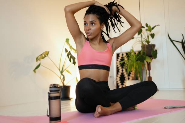 istock Satisfied young black woman sitting and relaxing after her work out 1352023732