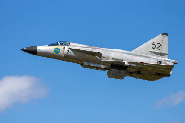 Military jet fighter airplane flying over the sea