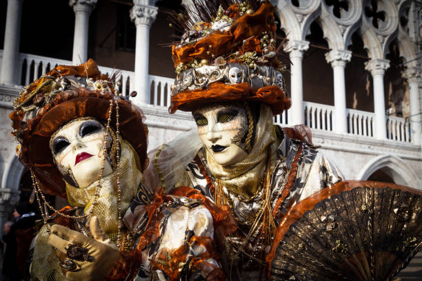 Costumed couple on the Piazza San Marco during Venice Carnival. Venice, Italy - June 6, 2013