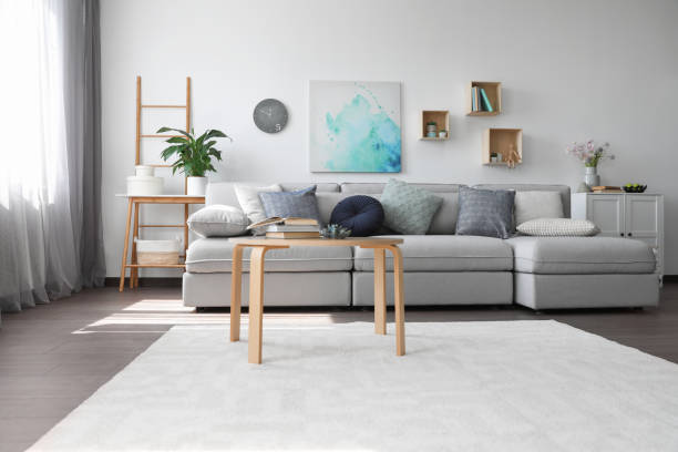 istock Elegant living room with comfortable sofa and wooden table. Interior design 1352025141