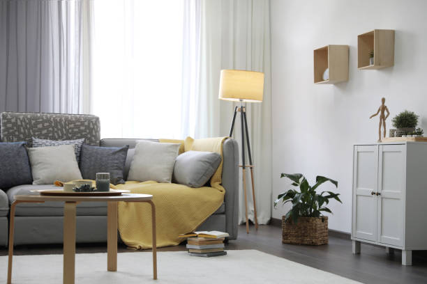 istock Elegant living room with comfortable sofa near window. Interior design 1352025880