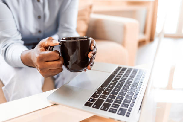 istock Young woman drinking coffee while working from home 1352025915