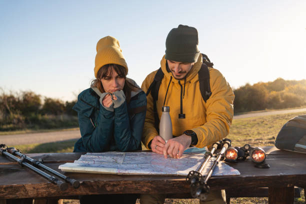 istock While taking a break from the long hike, couple looking at the map so they know in which direction to continue the hike 1352025919