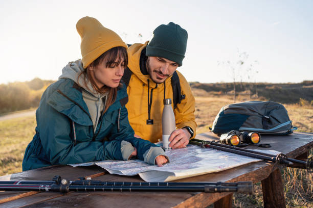 istock With a help od the map, young couple trying to orientate, while taking a small break from hiking 1352025999