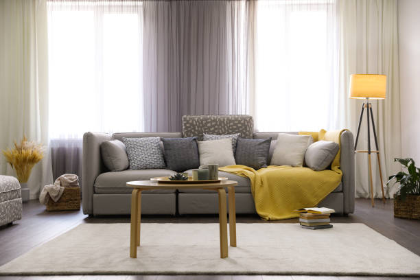 istock Elegant living room with comfortable sofa near windows. Interior design 1352026246