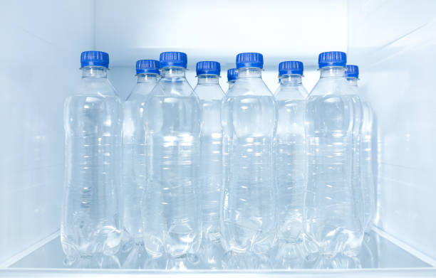 istock Bottles of pure water on shelf inside refrigerator 1352027897