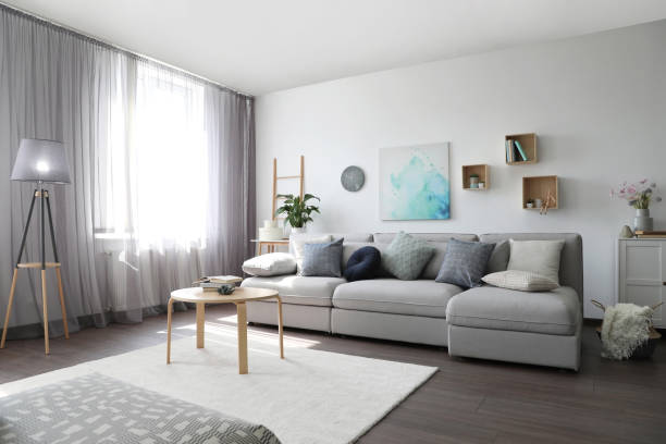 istock Elegant living room with comfortable sofa near window. Interior design 1352028355