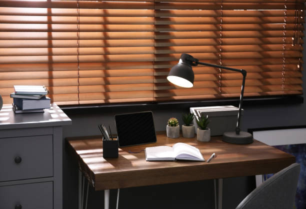 istock Stylish room interior with comfortable workplace near window 1352028512