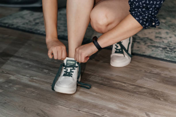 istock The bride puts on white sneakers with green laces. 1352029017