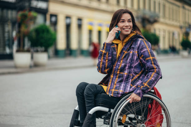 istock Woman with disability using a smartphone while out in the city 1352029237