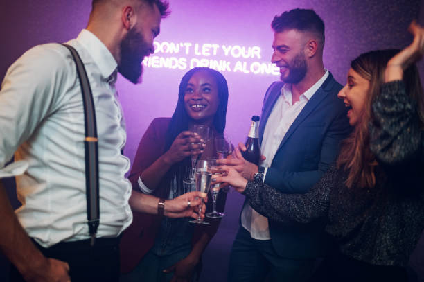 istock Friends dancing on a party in a club while drinking champagne 1352029301