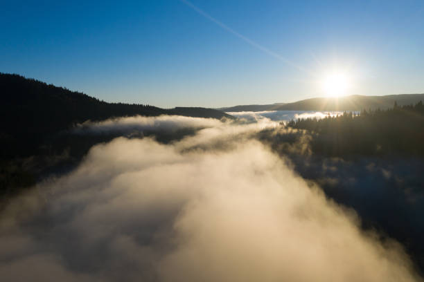 istock Aerial view of mountain sunrise above clouds 1352029539
