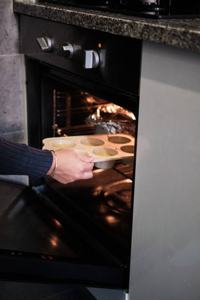 istock put cupcakes in the oven at home to bake 1352032146