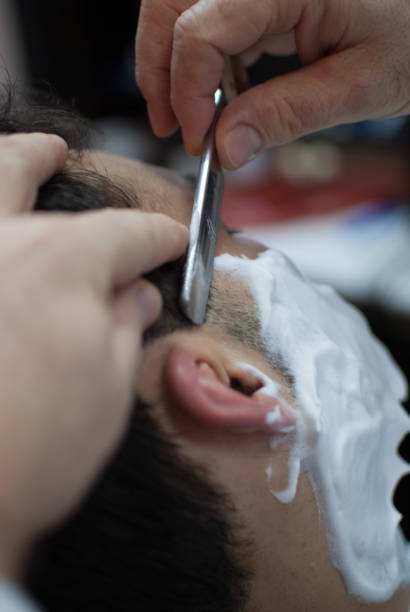 istock Adult man taking a shave at the barber 1352036778