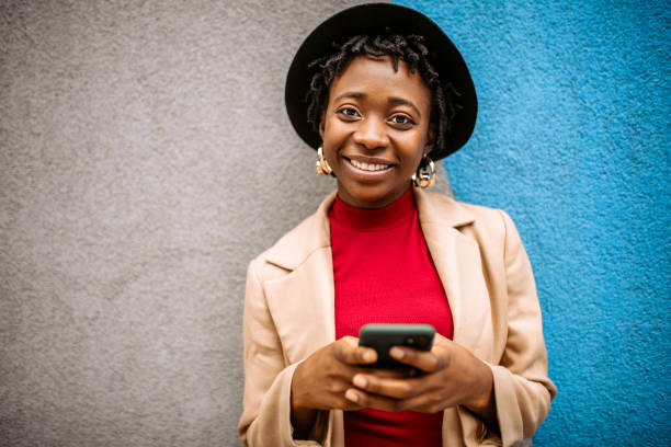 istock Young stylish black woman posing on a wall background 1352038429