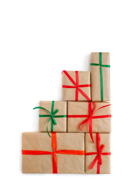 Handmade christmas gift boxes wraped in recycled paper with ribbon bow isolated on white background. Top view, flat lay. stock photo