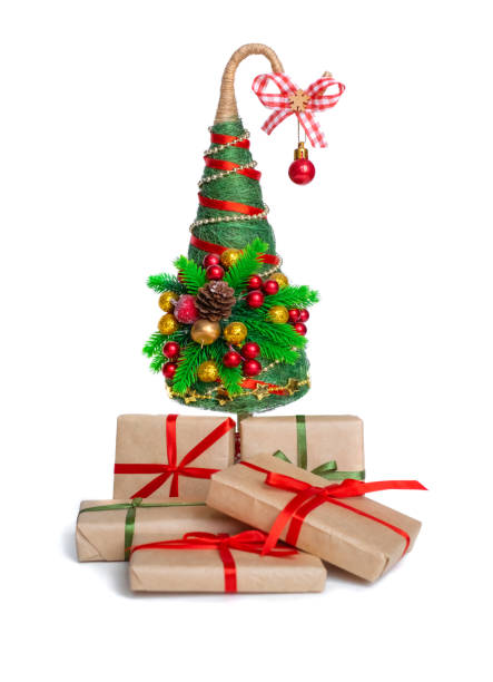 istock Decorated gold Christmas tree with presents for new year isolated on white background 1352040564