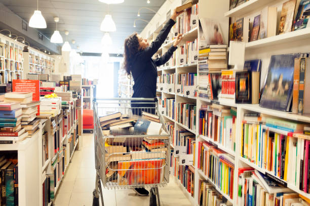 Restocking shelf in the bookstore stock photo